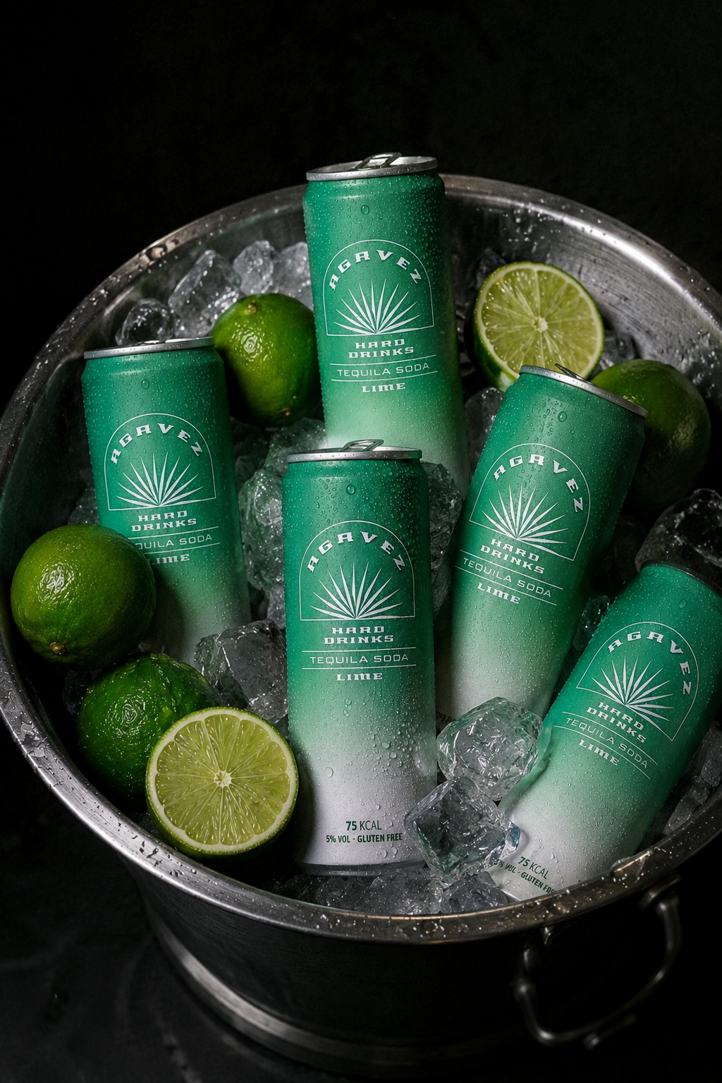 Agavez cans on ice with fresh limes in a metal bucket