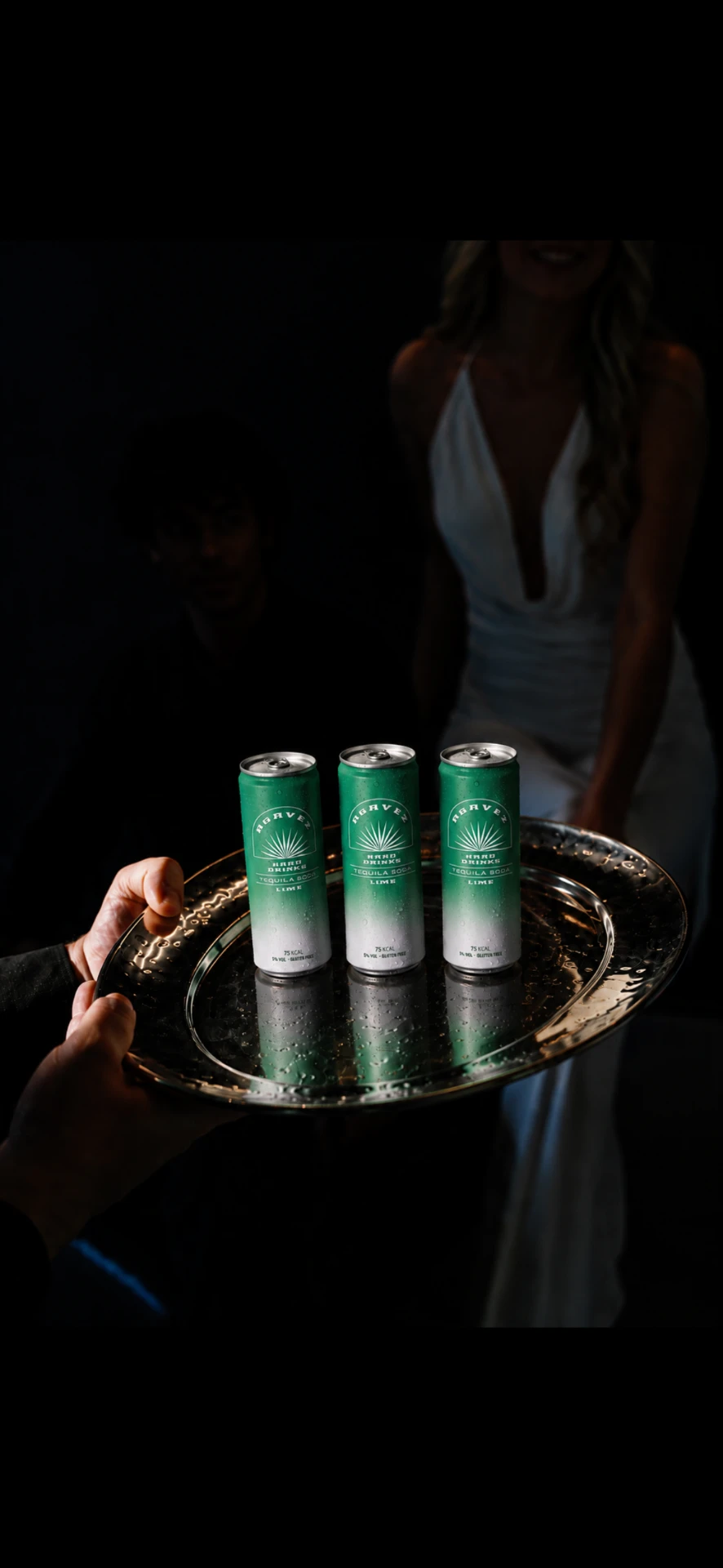 Three Agavez cans served on a silver tray